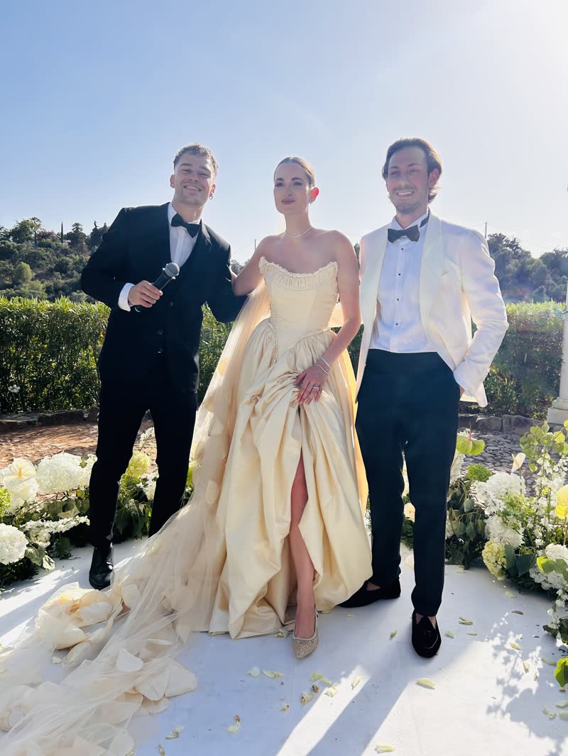 Vova with a couple after an outdoor wedding ceremony