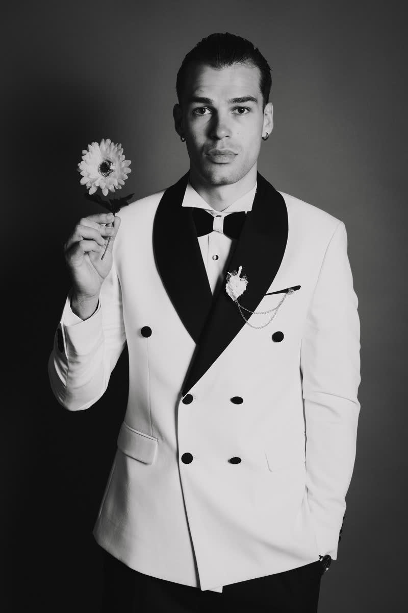 Black and white portrait of Vova holding a flower