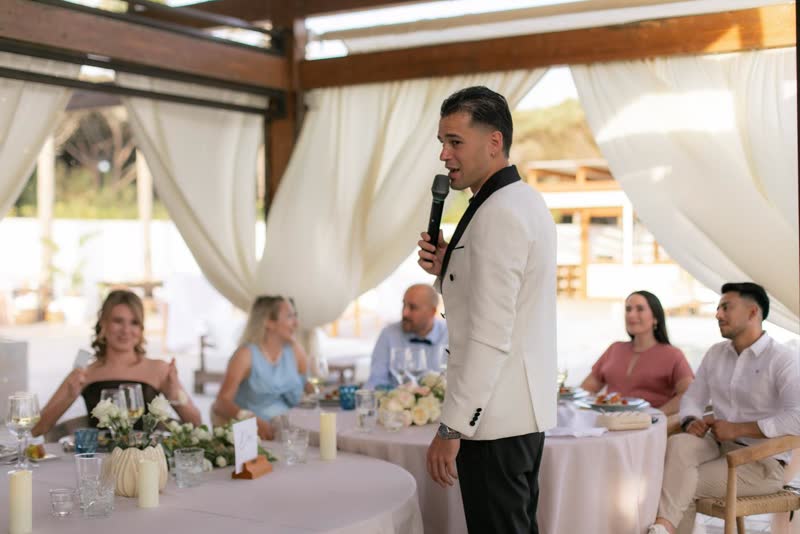 Vova speaking among guests at an intimate wedding in Cadiz